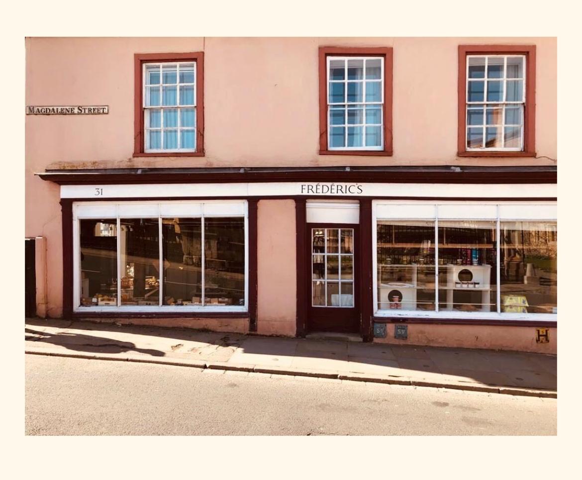 Storefront with 'Frederics' sign on a pink building
